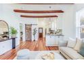 Open-concept living space with hardwood floors and rustic barn door offering modern living at 2227 Mount Pleasant St, Charleston, SC 29403