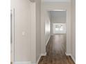 Inviting hallway featuring sleek, dark-toned hardwood flooring and views of the home's open-concept living spaces at 223 Sugarberry Lane, Moncks Corner, SC 29461