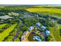 Aerial view of a condo on a lake surrounded by trees, marshlands and other neighborhood homes at 2472 Racquet Club Dr, Seabrook Island, SC 29455