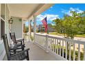 Inviting front porch with rocking chairs, offering a relaxing outdoor space with neighborhood views at 2842 Rutherford Way, Charleston, SC 29414