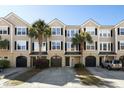 Beautiful townhomes featuring garages, front doors, and landscaped yards with palm trees at 2920 Woodland Park Dr, Mount Pleasant, SC 29466