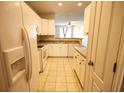 Well-lit kitchen with ample cabinet space and a view into the adjacent living area at 2926 Sugarberry Lane Ln, Johns Island, SC 29455