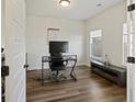 Home office featuring wood floors, a modern desk setup, natural light, and neutral walls at 3215 Safe Harbor Way, Charleston, SC 29414