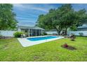 Large in-ground pool and well-manicured lawn are perfect for outdoor enjoyment and entertaining at 3308 Island Estates Dr, Johns Island, SC 29455
