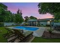 Backyard pool featuring an inviting screened-in porch and two cushioned lounge chairs at 3308 Island Estates Dr, Johns Island, SC 29455