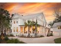 Charming two-story home with a welcoming front porch and beautiful sunset backdrop at 3894 Sawyers Island Dr, Mount Pleasant, SC 29466