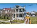 Charming two-story home with a large front porch, colorful door, and well-maintained landscaping at 4 Kenilworth Ave, Charleston, SC 29403