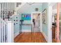 Inviting foyer features hardwood floors, elegant staircase, and stylish decor at 4 Kenilworth Ave, Charleston, SC 29403