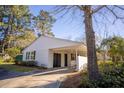 Classic white siding complements this lovely single-story home, featuring a convenient carport and well-kept lawn space at 412 Arlington Dr, Charleston, SC 29414