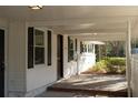 Inviting covered porch with brick flooring, perfect for relaxing and enjoying the neighborhood views at 412 Arlington Dr, Charleston, SC 29414