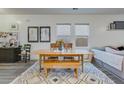 Cozy dining area with a wooden table, bench seating, and large windows at 429 Pender Woods Dr, Summerville, SC 29486