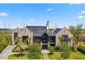 Beautiful brick home featuring a well-manicured lawn, lush landscaping, and a grand entrance at 430 Fish Tale Rd, Charleston, SC 29492