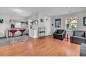 Spacious living room with hardwood floors, a modern kitchen, large windows, and comfortable seating at 4445 Old Park Rd, North Charleston, SC 29405