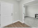 Inviting entryway features wood-look flooring and a view into a carpeted room at 5115 Cranesbill Way, Johns Island, SC 29455