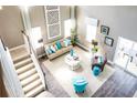 Bright and airy living room featuring a neutral color palette, tall windows, and comfortable seating at 523 Verdi Dr, Summerville, SC 29486
