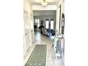 Inviting hallway with modern flooring and decor that leads to a brightly lit living area at 572 Tidewater Chase Ln, Summerville, SC 29486