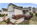 Charming home exterior boasts manicured landscaping, walkway, and attached garage at 614 Battery Edge Dr, Summerville, SC 29486