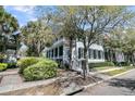 Beautiful two-story home showcasing a welcoming porch and lush landscaping at 740 Stucco Ln, Mount Pleasant, SC 29464