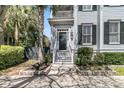 Charming home's entrance features a quaint porch and well-manicured landscaping at 740 Stucco Ln, Mount Pleasant, SC 29464