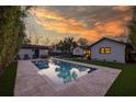Stunning backyard with a sparkling pool, offering a private oasis for relaxation and entertainment with a beautiful sunset view at 1 Riverdale Dr, Charleston, SC 29407
