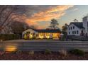 Charming home with a well-maintained front yard and stylish curb appeal, showcasing inviting exterior lighting and a modern fence at 1 Riverdale Dr, Charleston, SC 29407