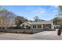 Well-manicured home exterior featuring modern architectural details, a driveway, beautiful landscaping and updated features at 1 Riverdale Dr, Charleston, SC 29407