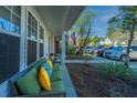 Relaxing front porch with cozy seating and view of driveway parking at 1002 Elm Hall Cir, Summerville, SC 29483