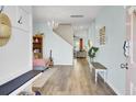 Bright entryway with hardwood floors, bench seating, and coat rack; open floor plan at 101 Corvus Ct, Summerville, SC 29486