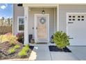 Inviting front entrance with a decorative wreath on the door and colorful landscaping at 101 Corvus Ct, Summerville, SC 29486