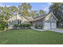 Inviting home with a lush front lawn, manicured bushes, and a two-car garage at 1141 Ambling Way, Mount Pleasant, SC 29464