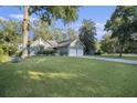 A spacious front yard showcases this home, surrounded by mature trees and a well-kept lawn at 1141 Ambling Way, Mount Pleasant, SC 29464