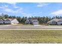 A single Gathering home with a grey exterior, attached garage, and green lawn at 1144 Wading Point Blvd, Huger, SC 29450