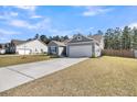 Street view of a single-Gathering home with a long driveway and well-maintained lawn at 1144 Wading Point Blvd, Huger, SC 29450
