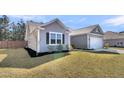 Side view of a gray single-Gathering home with green grass and landscaping at 1144 Wading Point Blvd, Huger, SC 29450