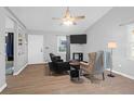 Bright living area with ample seating, a ceiling fan, and a mounted television at 115 Tennyson Way, Summerville, SC 29486