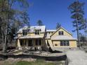 Home under construction showcasing the exterior siding and roof against a bright blue sky at 118 Peninsula Dr, Ravenel, SC 29470