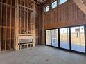 Spacious living room under construction with fireplace and large sliding glass doors to the deck at 118 Peninsula Dr, Ravenel, SC 29470