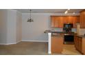 Open kitchen with wooden cabinets, stainless steel appliances, and breakfast bar at 1204 Grove Park Dr, Charleston, SC 29414