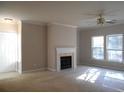 Bright living room with fireplace, ceiling fan, and natural light at 1204 Grove Park Dr, Charleston, SC 29414
