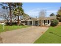 Attractive single-story home boasting a manicured lawn, a welcoming front porch, and a long driveway at 121 Milton Dr, Goose Creek, SC 29445
