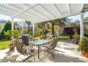 Covered patio with outdoor furniture, a grill, and a pergola perfect for enjoying the backyard oasis at 123 Thousand Oaks Ct, Summerville, SC 29485