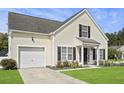 Two-story home featuring a garage, manicured lawn, and a welcoming front entrance at 1249 Shadow Mist Ln, Charleston, SC 29492