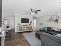 Cozy living room with dark sofa, area rug, and open floor plan at 1249 Shadow Mist Ln, Charleston, SC 29492