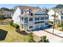 A charming two-story home, with an attractive facade, private garages and landscaped surroundings at 1457 Red Tide Rd, Mount Pleasant, SC 29466