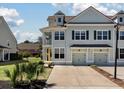 Charming two-story home with a yellow door, complemented by manicured landscaping and a private entrance at 1457 Red Tide Rd, Mount Pleasant, SC 29466