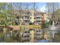 Gorgeous condo building reflected in the serene pond with fountain at 1522 Telfair Way, Charleston, SC 29412