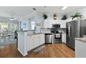 Bright kitchen featuring stainless steel appliances, granite countertops, and hardwood floors at 1522 Telfair Way, Charleston, SC 29412
