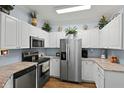 Modern kitchen features stainless steel appliances, white cabinets, and decorative backsplash at 1522 Telfair Way, Charleston, SC 29412