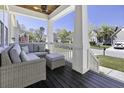 Relaxing front porch with comfortable seating, ideal for enjoying the neighborhood views at 1704 Tolbert Way, Mount Pleasant, SC 29466