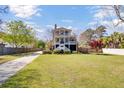 Beautiful exterior of a two-story home with mature trees, a large lawn, and a long driveway at 185 5Th Ave, Mount Pleasant, SC 29464